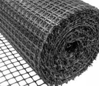 Roll of black biaxial geogrid reinforcement over a mesh geotextile layer