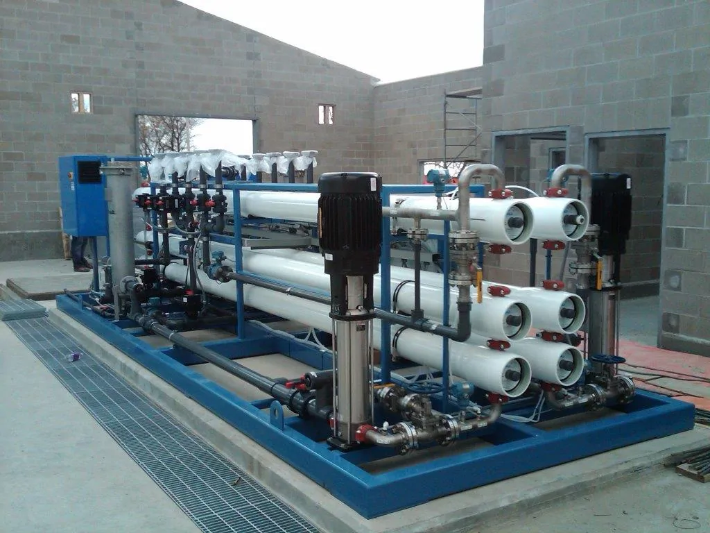 Blue skid-mounted reverse osmosis water treatment system with white membrane vessels and pumps in a building under construction